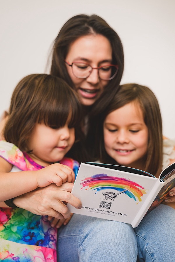 Mother and daughters reading a book together